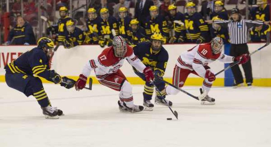 John Wiitala watches Dave Gust sprint ahead of the Michigan defense