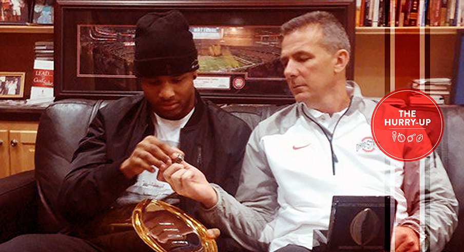 Keandre Jones and Urban Meyer examine some Buckeye hardware.