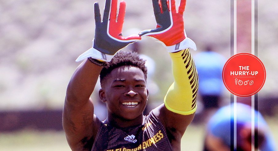 Sam Bruce throwing up "The U" at a 7-on-7 tournament.