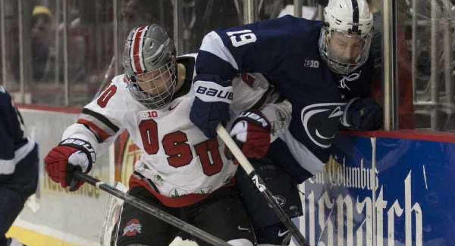 Ohio State's Janik Moser and Penn State's Eric Scheid do battle along the wall.