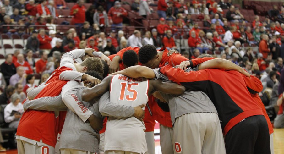 The Buckeyes huddle up before the tip against their rivals.