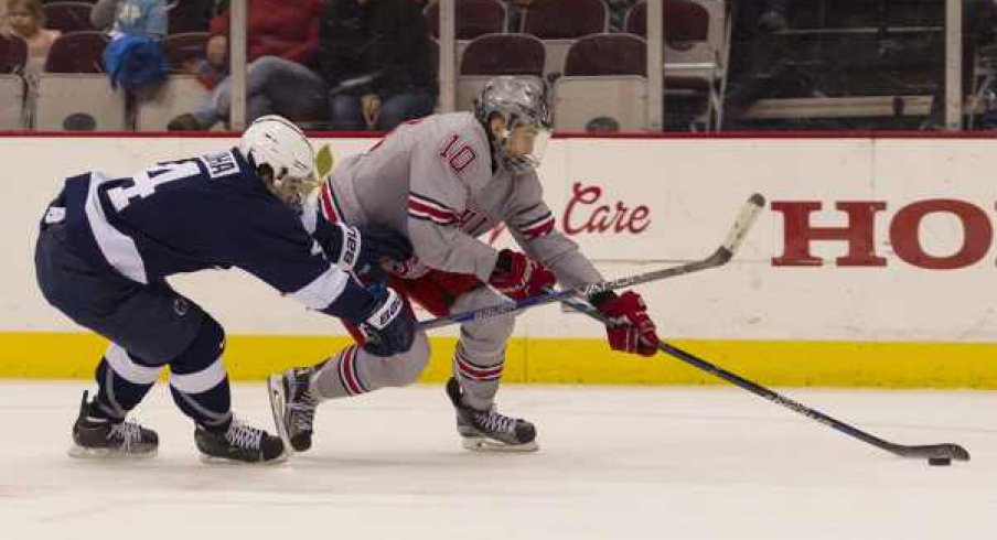 Ohio State's John Wiitala protects the puck from Luke Juha of Penn State