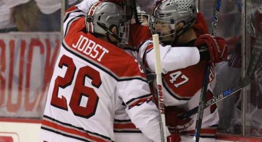 Mason Jobst and Josh Healey celebrate a goal for Ohio State men's hockey.