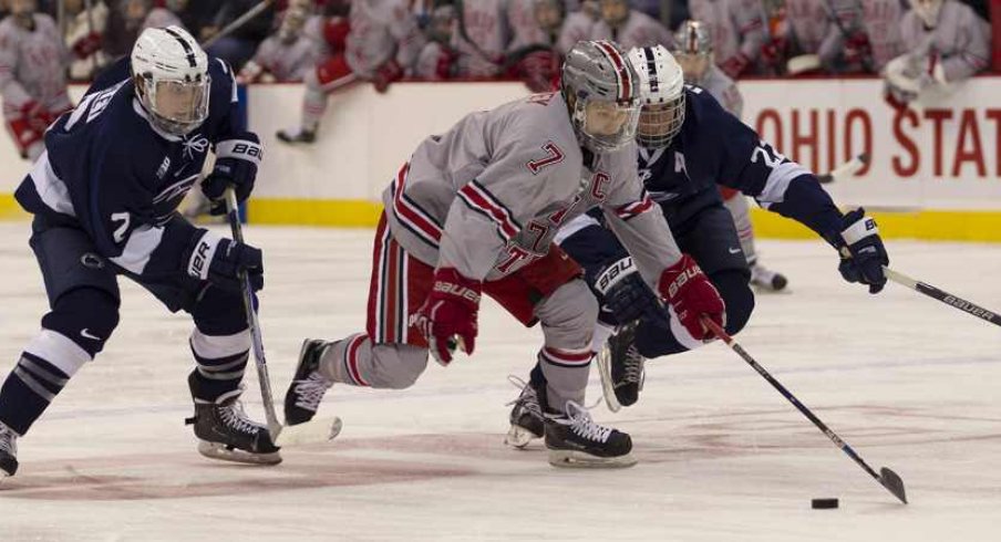 Ohio State's Nick Schilkey splits the Penn State defenders.