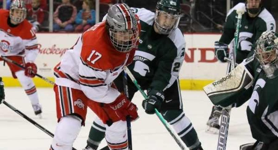 Ohio State forward David Gust goes to the net against Michigan State. 