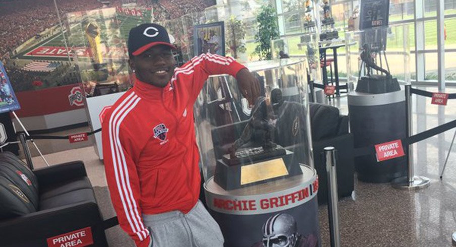 Five-star wide receiver Tyjon Lindsey poses with Archie Griffin's Heisman Trophy at the Woody Hayes Athletic Center