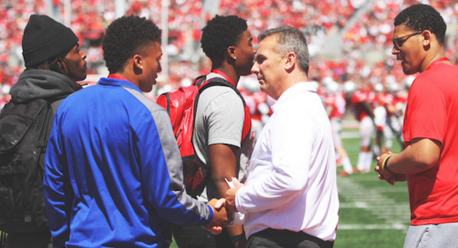 Urban Meyer surrounded by Buckeye recruits. 