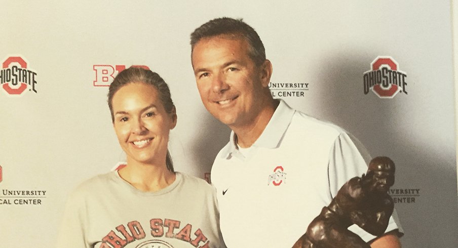 Kristin Conrad and Urban Meyer pose for a photo at the Ohio State Football Women's Clinic