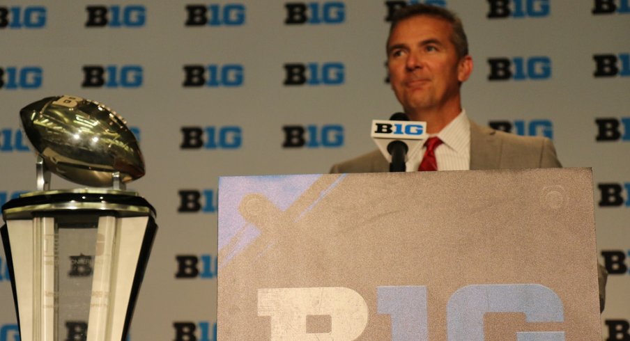 Urban Meyer and the B1G championship trophy.