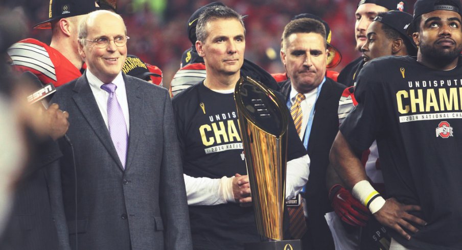 Urban Meyer and the CFP trophy.