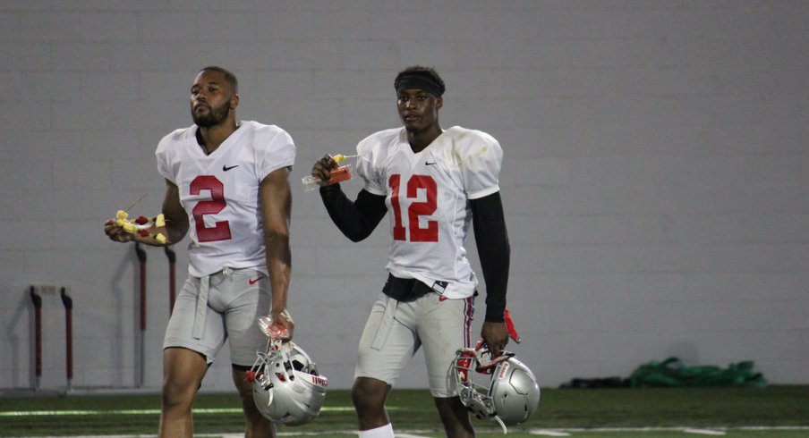 Marshon Lattimore, Denzel Ward walk off the Ohio State practice field. 