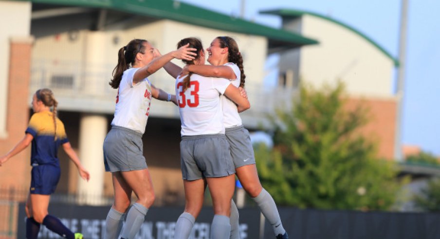 Women's soccer celebrates victory.