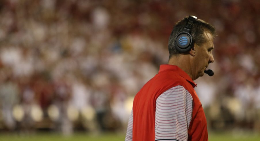 Urban Meyer strolls the sidelines in Norman.