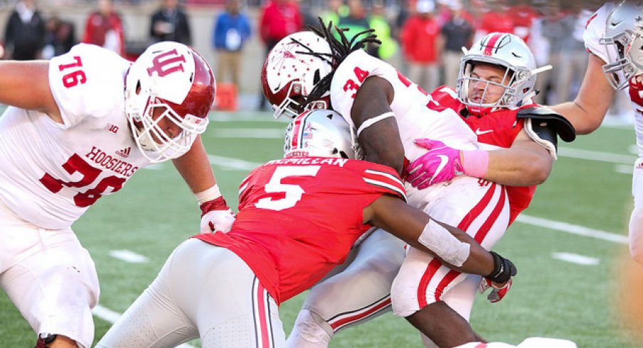 Nick Bosa and Raekwon McMillan combine for a tackle for a loss against Indiana.