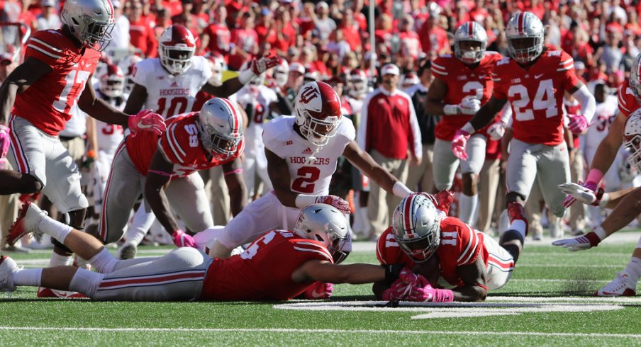 Jalyn Holmes and Sam Hubbard dive for a fumble against Indiana. 