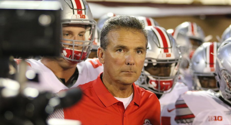 Urban Meyer leads his team on the field against Oklahoma. 