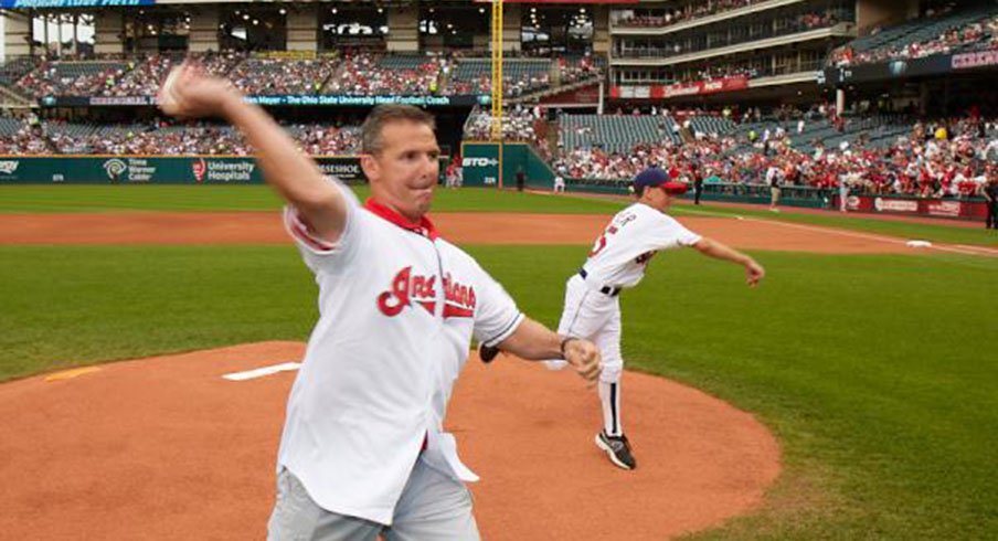 Urban Meyer, seen here throwing out the first pitch at an Indians game, is a huge baseball fan.