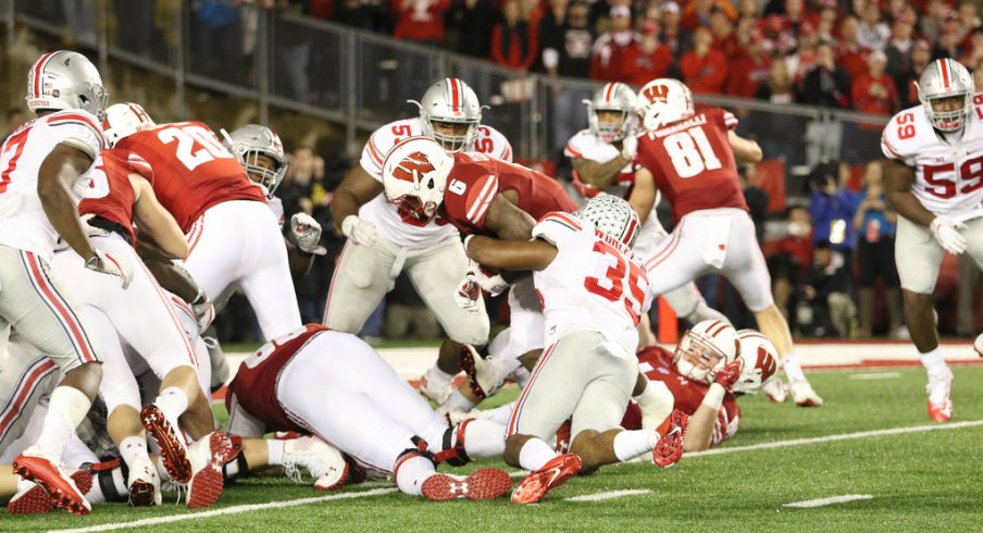 Chris Worley tackles Wisconsin RB Corey Clement.