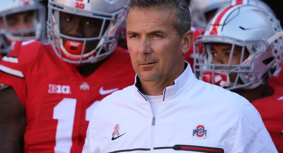 Urban Meyer leads his team on the field against Indiana. 