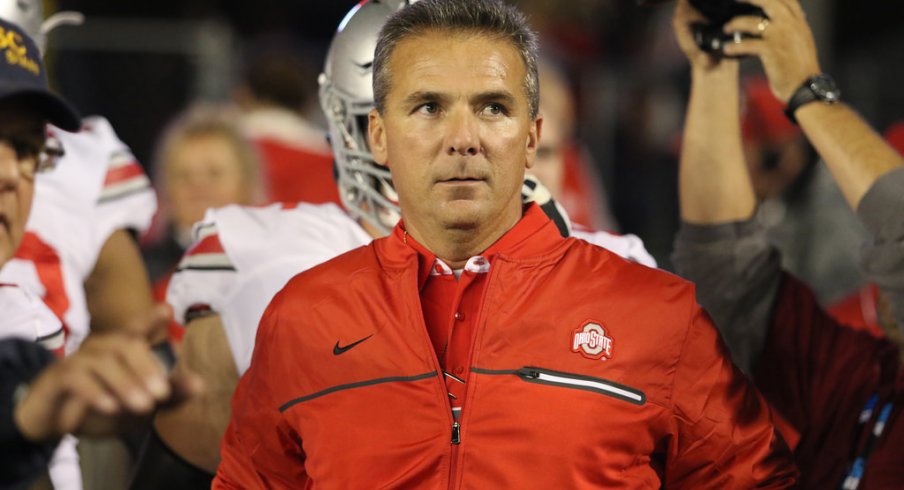 Urban Meyer leads Ohio State onto the field at Wisconsin. 
