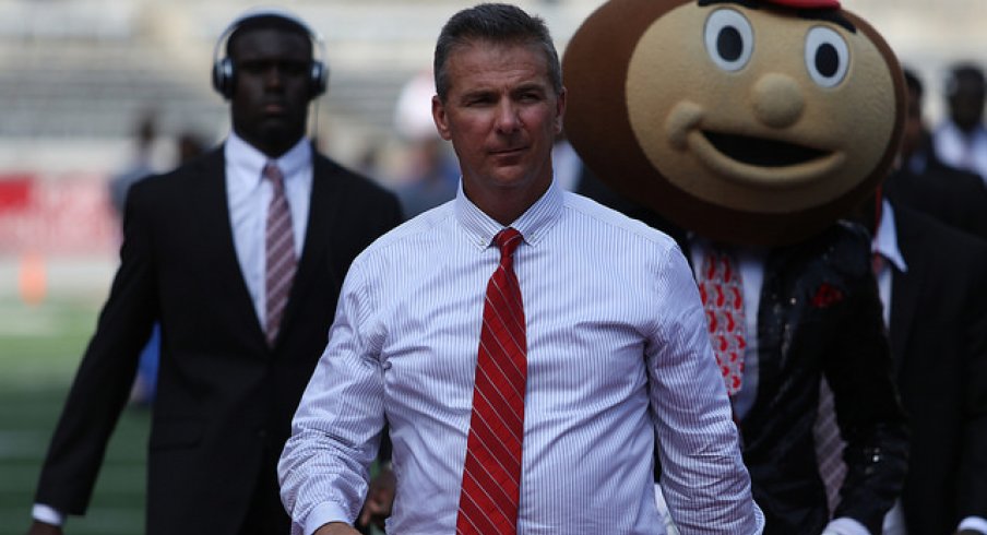 Urban Meyer rolls into Ohio Stadium with Brutus Buckeye.