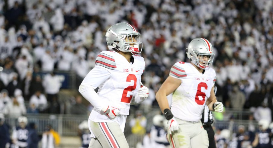 Marshon Lattimore and Sam Hubbard jog off the field following a series at Penn State. 