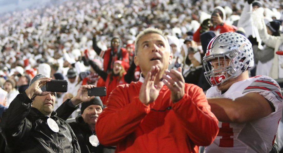 Urban Meyer leads his team out onto the field at Penn State. 