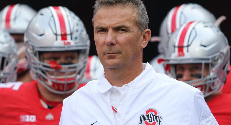 Urban Meyer leads Ohio State onto the field vs. Northwestern. 