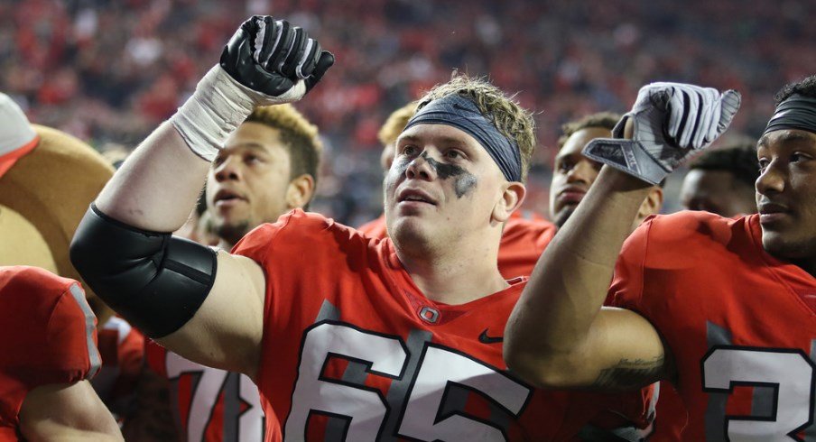 Pat Elflein celebrates an Ohio State victory with his teammates.