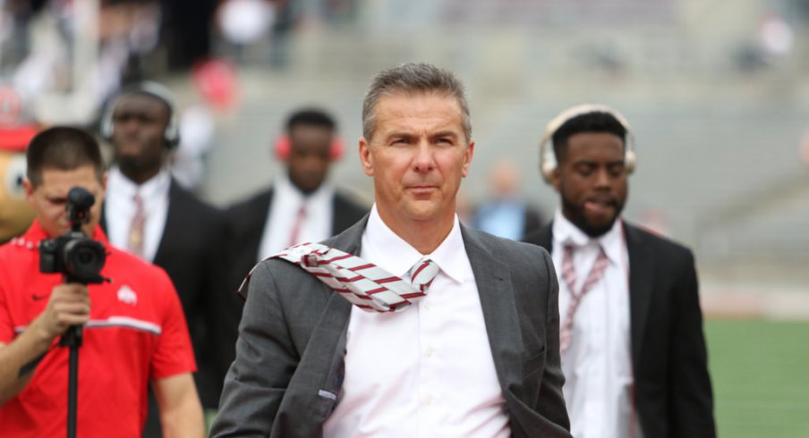 Urban Meyer walks into Ohio Stadium. 