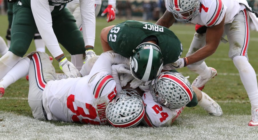 Malik Hooker and Chris Worley pick off a two-point conversion against Michigan State. 