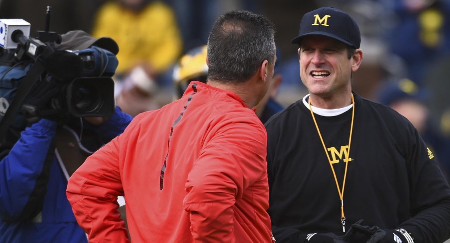 Nov 28, 2015; Ann Arbor, MI, USA; Ohio State Buckeyes head coach Urban Meyer and Michigan Wolverines head coach Jim Harbaugh prior to the game at Michigan Stadium. Mandatory Credit: Tim Fuller-USA TODAY Sports