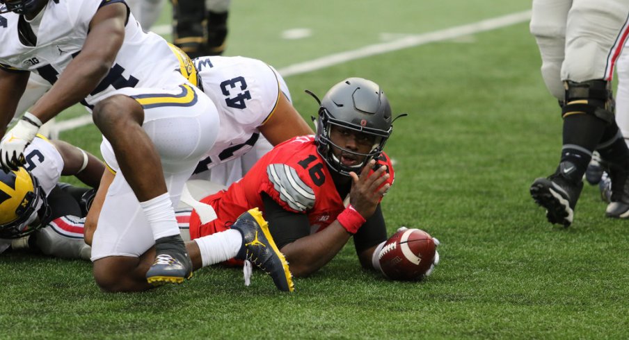 J.T. Barrett reaches for a first down vs. Michigan. 