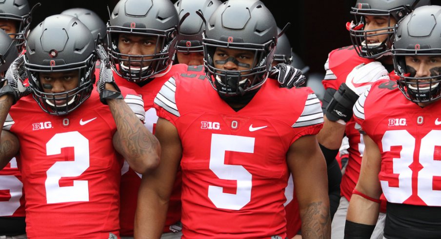 Dontre Wilson and Raekwon McMillan lead Ohio State onto the field. 