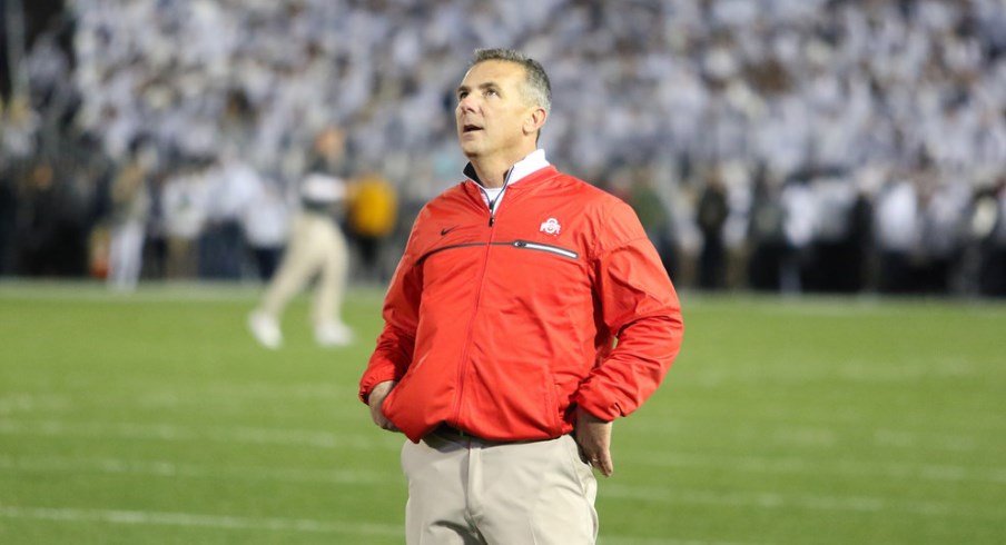 Urban Meyer looks at a replay during a game.