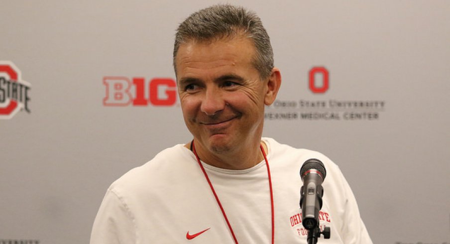 Urban Meyer talks to media.