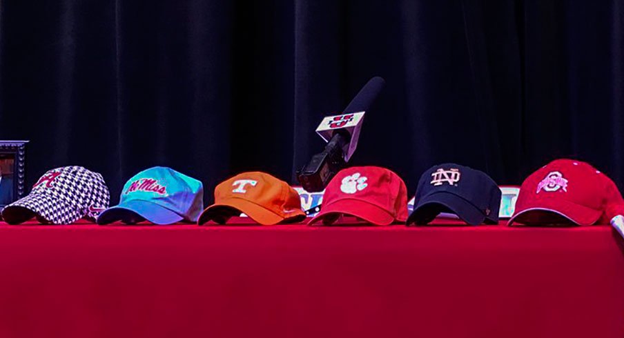Hats sit on a table prior to five-star offensive tackle Trey Smith's announcement