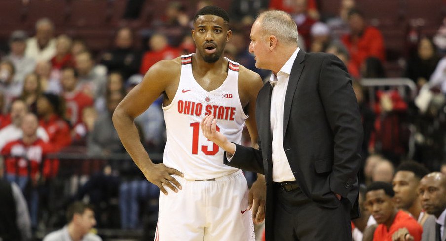 Ohio State coach Thad Matta talks with point guard JaQuan Lyle. 