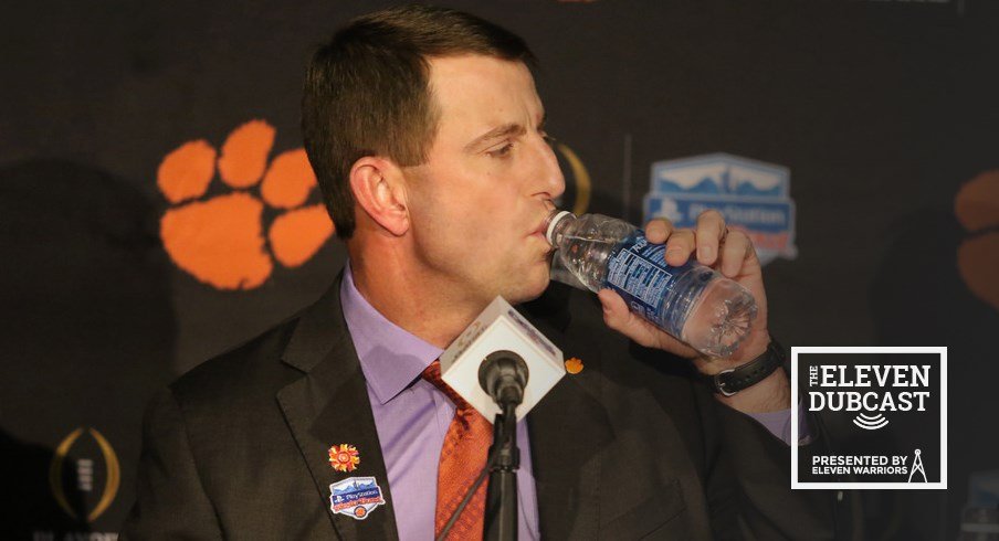 Dabo Swinney takes a drink of water in a press conference before the Fiesta Bowl.