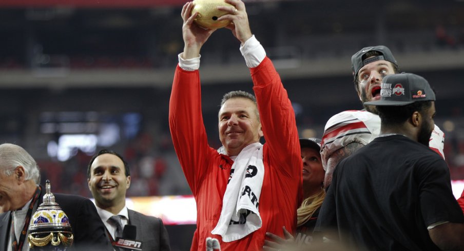 Urban Meyer lifts the 2016 Battlefrog Fiesta Bowl trophy.