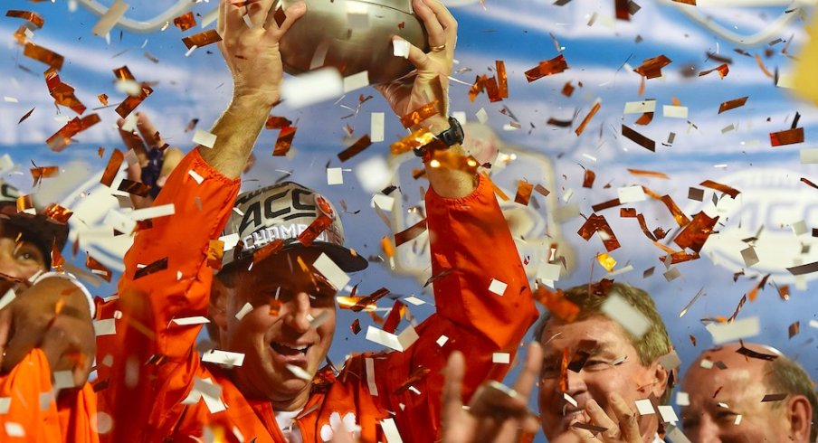 Clemson coach Dabo Swinney celebrates with the 2016 ACC championship trophy.