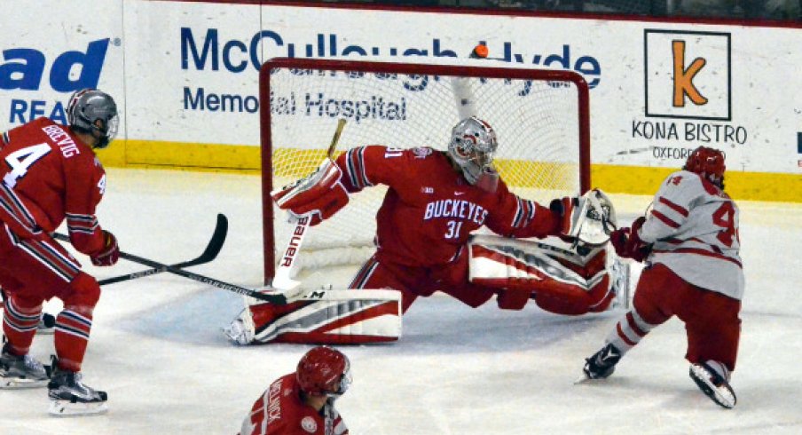 Drew Brevig looks on as Ohio State's Matt Tomkins makes a save against Miami.