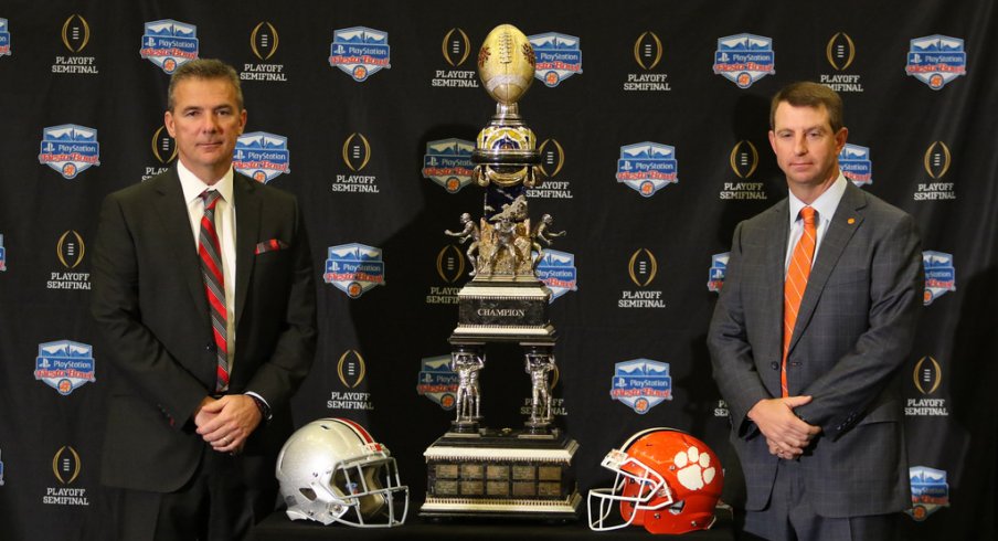 Urban Meyer and Dabo Swinney pose with the Fiesta Bowl trophy. 