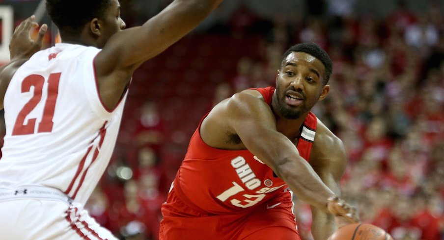 Ohio State point guard JaQuan Lyle makes a pass at Wisconsin. 
