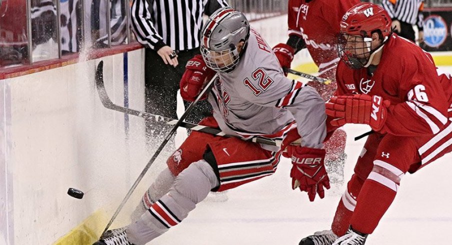 Ohio State forward Miguel Fidler protects the puck against a Wisconsin Badger.