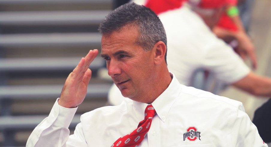 Urban Meyer salutes before a game.