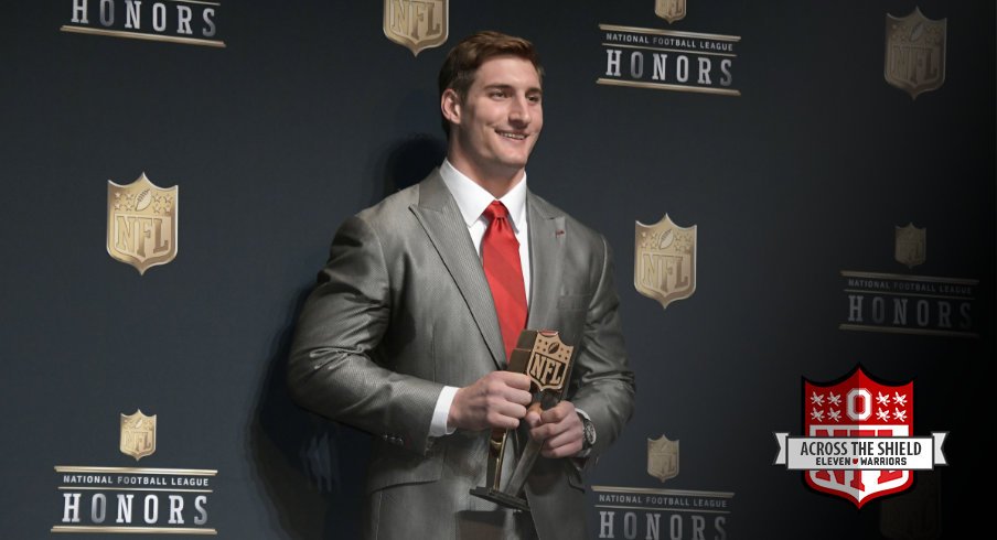 Joey Bosa poses with his NFL Defensive Rookie of the Year trophy.