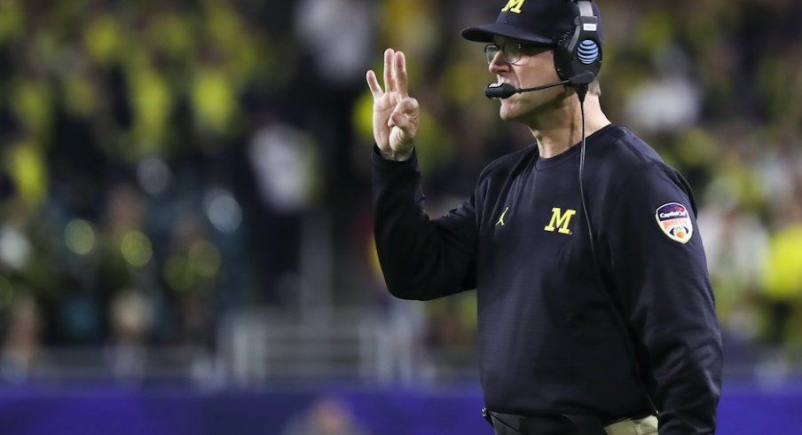  Dec 30, 2016; Miami Gardens, FL, USA; Michigan Wolverines head coach Jim Harbaugh (center) signals from the sideline in the second quarter against the Florida State Seminoles at Hard Rock Stadium. Mandatory Credit: Logan Bowles-USA TODAY Sports