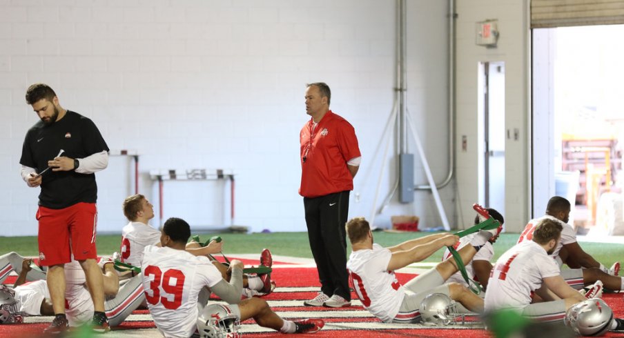 New linebackers coach Bill Davis watches his players warm up.