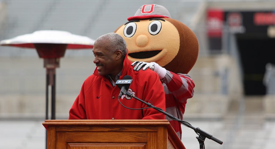 Brutus Buckeye rubs Gene Smith's shoulders.